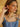 Model wearing cherry earrings with gold accents.