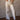 High rise striped denim jeans with rhinestone stud accents, button and zipper closure, belt loops, four pockets, and raw hem.