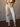 High rise striped denim jeans with rhinestone stud accents, button and zipper closure, belt loops, four pockets, and raw hem.