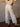 High rise striped denim jeans with rhinestone stud accents, button and zipper closure, belt loops, four pockets, and raw hem.