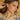 Model wearing cherry earrings with gold accents.
