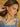 Model wearing cherry earrings with gold accents.